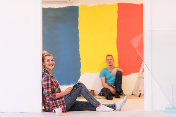 Image showing Happy young couple relaxing after painting