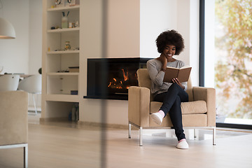 Image showing black woman at home reading book