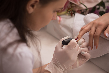 Image showing Woman hands receiving a manicure