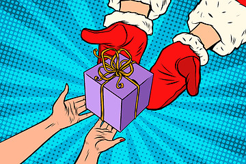 Image showing Santa Claus gives Christmas gift