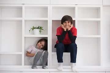 Image showing young boys posing on a shelf