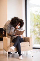 Image showing multiethnic couple hugging in front of fireplace