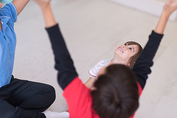 Image showing young boys having fun on the floor