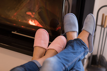 Image showing Young couple  in front of fireplace