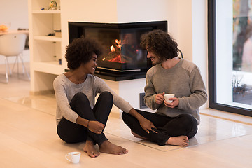 Image showing multiethnic couple  in front of fireplace