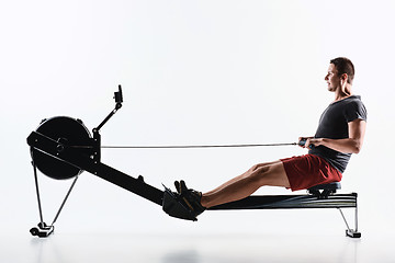 Image showing Man Using A Press Machine In A Fitness Club.