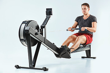 Image showing Man Using A Press Machine In A Fitness Club.