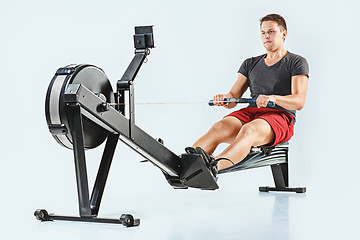 Image showing Man Using A Press Machine In A Fitness Club.