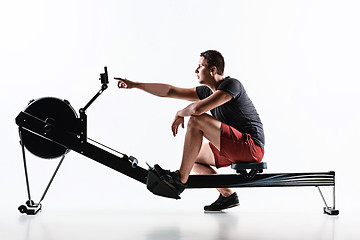 Image showing Man Using A Press Machine In A Fitness Club.