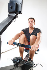 Image showing Man Using A Press Machine In A Fitness Club.