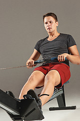 Image showing Man Using A Press Machine In A Fitness Club.