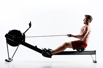 Image showing Man Using A Press Machine In A Fitness Club.