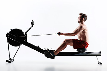 Image showing Man Using A Press Machine In A Fitness Club.