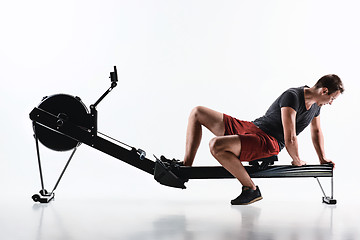 Image showing Man Using A Press Machine In A Fitness Club.