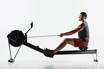 Image showing Man Using A Press Machine In A Fitness Club.