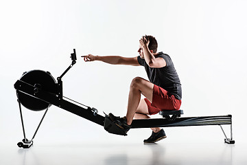 Image showing Man Using A Press Machine In A Fitness Club.