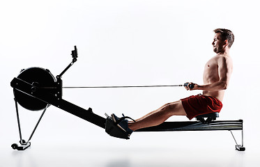 Image showing Man Using A Press Machine In A Fitness Club.