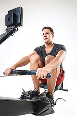 Image showing Man Using A Press Machine In A Fitness Club.