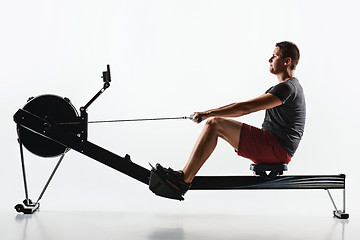 Image showing Man Using A Press Machine In A Fitness Club.