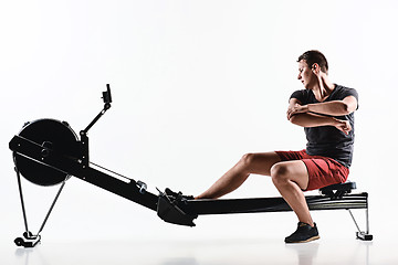 Image showing Man Using A Press Machine In A Fitness Club.