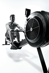 Image showing Man Using A Press Machine In A Fitness Club.
