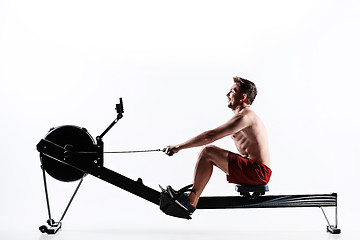 Image showing Man Using A Press Machine In A Fitness Club.