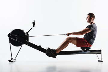 Image showing Man Using A Press Machine In A Fitness Club.