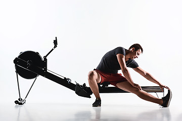 Image showing Man Using A Press Machine In A Fitness Club.