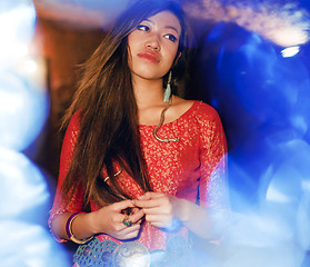 Image showing young pretty asian girl in bright colored interior on carpet