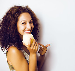 Image showing pretty young real tenage girl eating apple close up smiling