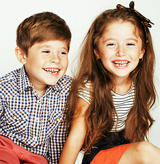 Image showing little cute boy and girl hugging playing on white background, ha