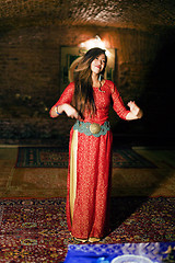 Image showing young pretty asian girl in bright colored interior on carpet