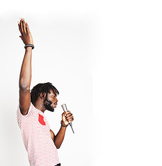 Image showing young handsome african american boy singing emotional with micro