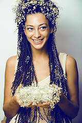 Image showing young pretty brunette girl with bouquet of little white spring f