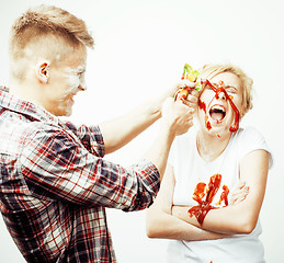 Image showing young pretty couple, lifestyle people concept: girlfriend and boyfriend cooking together, having fun, making mess isolated on white background 