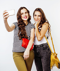 Image showing best friends teenage girls together having fun, posing emotional on white background, besties happy smiling, lifestyle people concept close up. making selfie