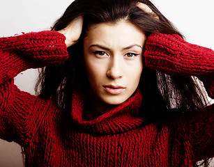 Image showing young pretty woman in sweater and scarf all over her face, lifes