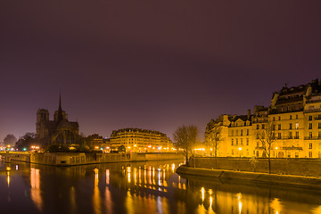 Image showing Notre Dame Cathedral with Paris cityscape at dusk