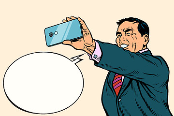 Image showing Asian businessman makes selfie