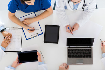 Image showing doctors with cardiogram and computers at hospital