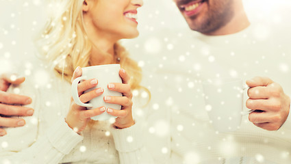 Image showing close up of happy couple with tea cups at home