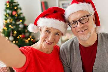 Image showing happy senior couple taking christmas selfie