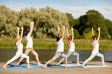 Image showing group of people making yoga exercises outdoors