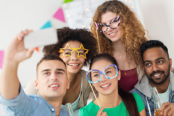 Image showing happy friends taking selfie at party