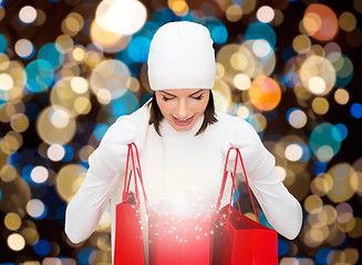 Image showing woman in winter hat with christmas shopping bags