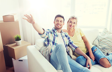 Image showing couple with boxes moving to new home and dreaming