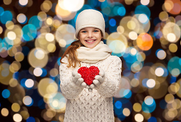 Image showing happy girl in winter clothes with red heart