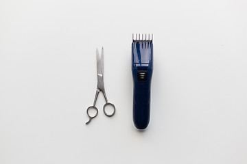 Image showing hair trimmer and scissors on white background