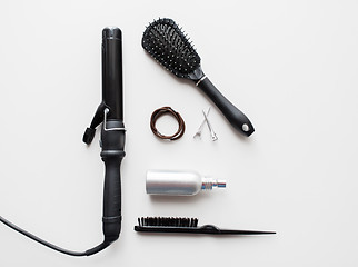 Image showing iron, brushes, styling spay, hair ties and pins