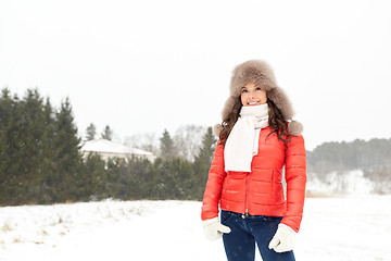 Image showing happy woman in winter fur hat outdoors